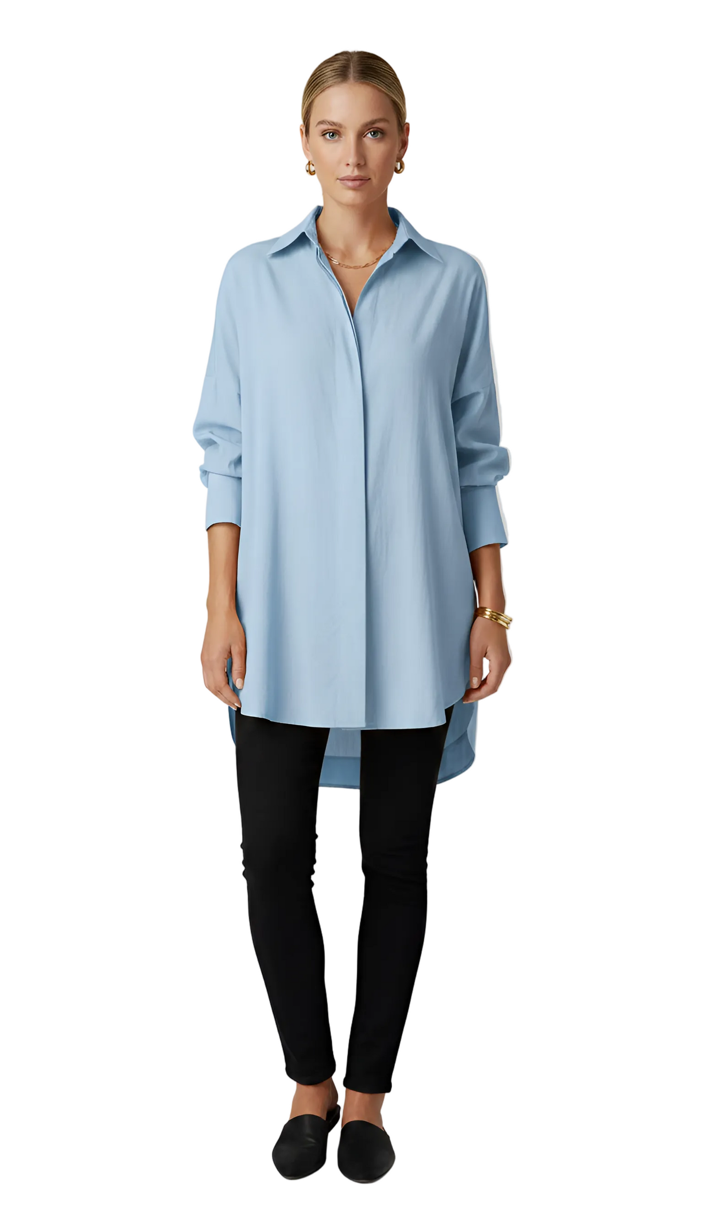 Woman wearing a light blue shirt and black pants on a gray background